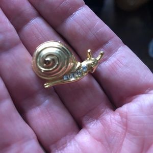 Brooch. Gold tone snail with crystal stones.